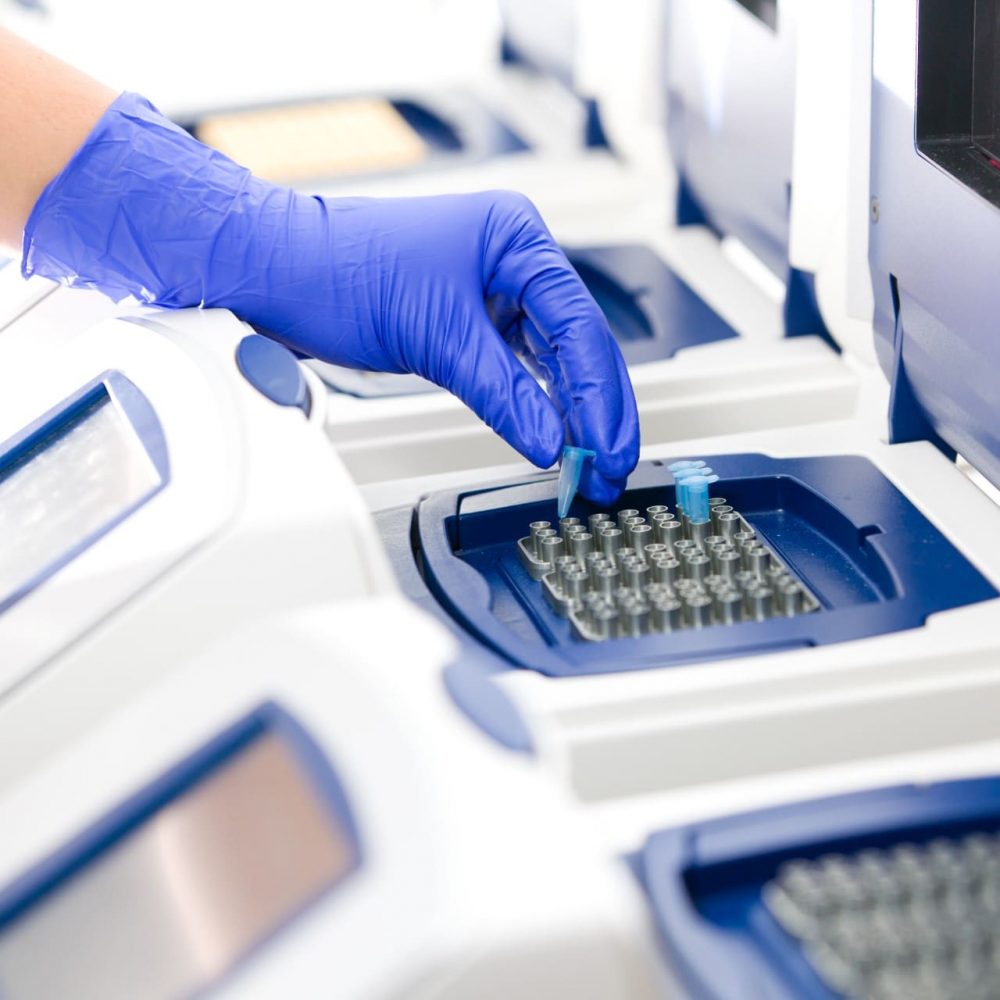 "Scientist with DNA copying, Real-time PCR cycler, wide"