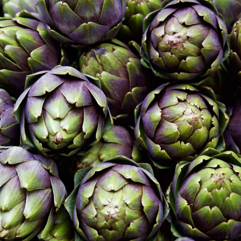 full frame of purple italian artichokes at the farmer's market